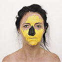 close up portrait of Trish with yellow and black paint on her face