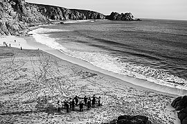 Circle of people congregating on the beach