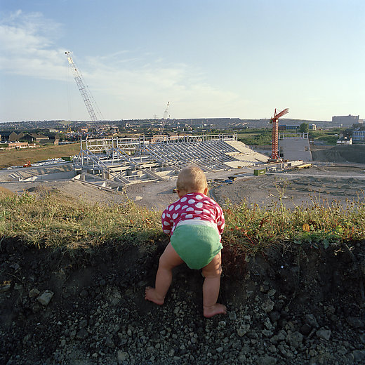Image of redevelopment in Sheffield, 1988, with a baby in the foreground